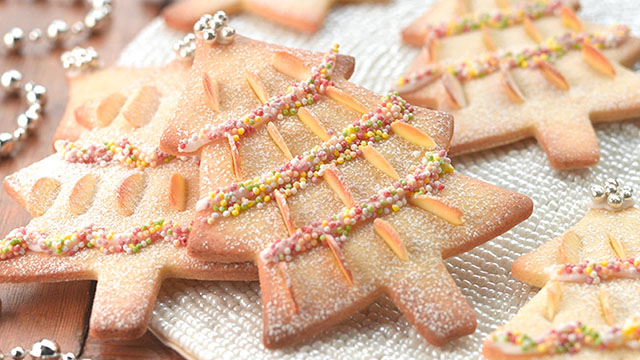 Almond Christmas Biscuits decorated with almonds, icing, sprinkles and silver balls