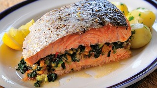 Carribean Salmon Fish served on a white plate with new potatoes and herbs