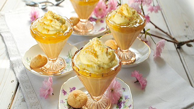 English Gooseberry Fools served in glass dishes with amaretti biscuits on floral plates