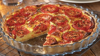 Lancashire Pizza served in a glass dish with a slice removed