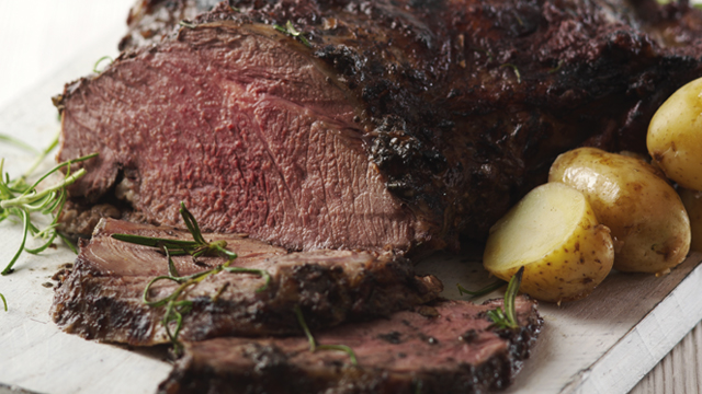 Butterflied Leg of Lamb with Anchovy, Garlic and Rosemay, sliced and served with new potatoes