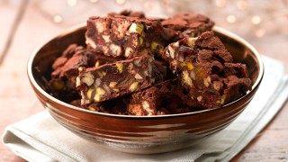 Nutty fridge cake dusted with cocoa powder and served in a bowl