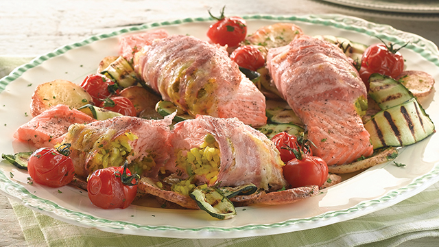 Pancetta Wrapped Salmon served with potatoes, vine tomatoes and courgette ribbons