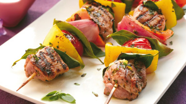 Mediterranean Pork Kebabs, served with orange and red peppers on plate