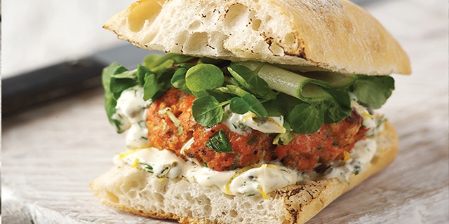 Fresh Salmon Burgers with lemon, caper and dill mayonnaise, served on a toasted ciabatta bun