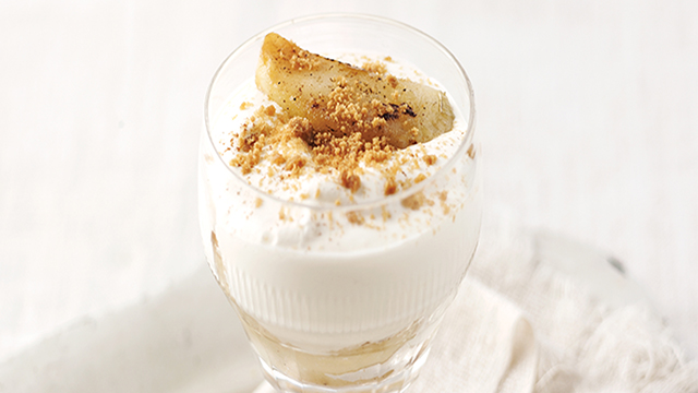 Spiced Apple Syllabub served in a glass topped with crushed ginger biscuits