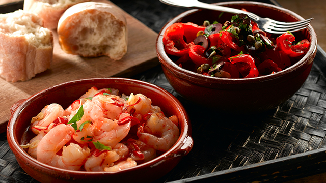 Spanish Red Pepper Salad with garlic and chilli prawns served in bowls with warm bread