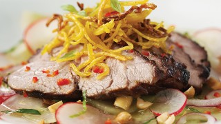 Thai Inspired Lamb Salad with Crispy Noodles served on top of salad with dressing