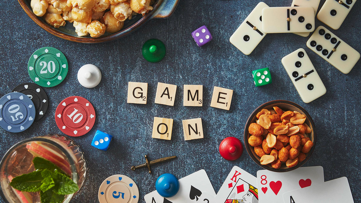 A winning night in blog header showing a games night table with 'Game on' spelt out in scrabble letters