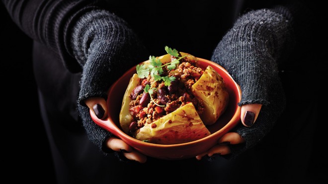 Jacket Potato with Chilli Con Carne in a bowl topped with coriander