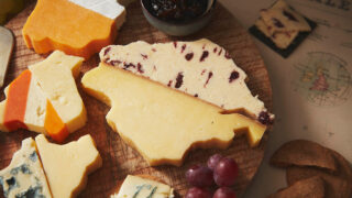 Variety of cheeses cut in the shape of counties and fitted together