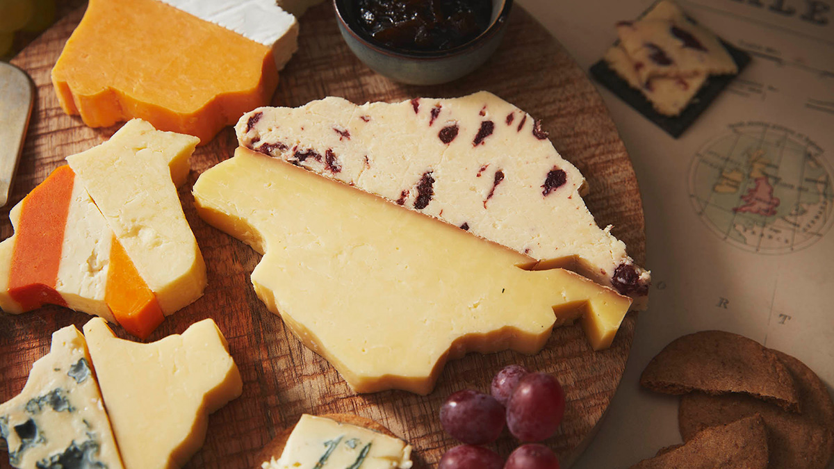 Variety of cheeses cut in the shape of counties and fitted together