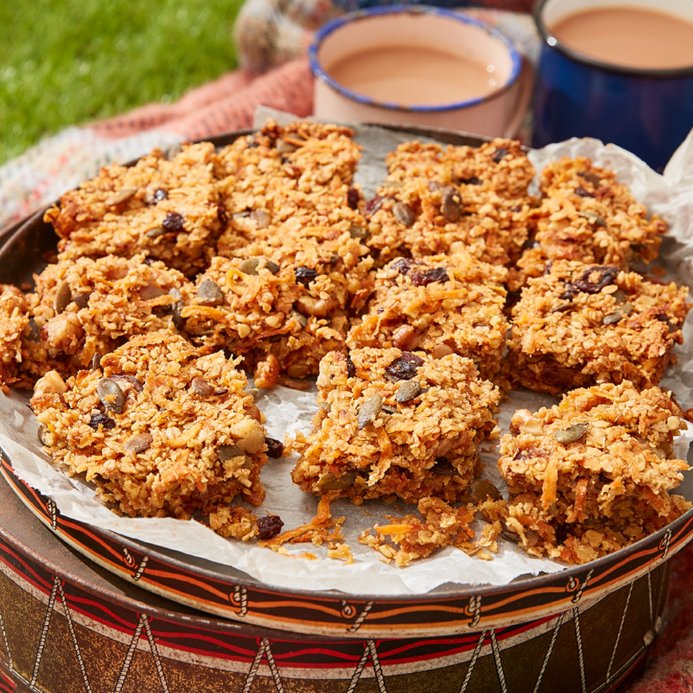 Image of carrot cake flapjack with two brews in the background