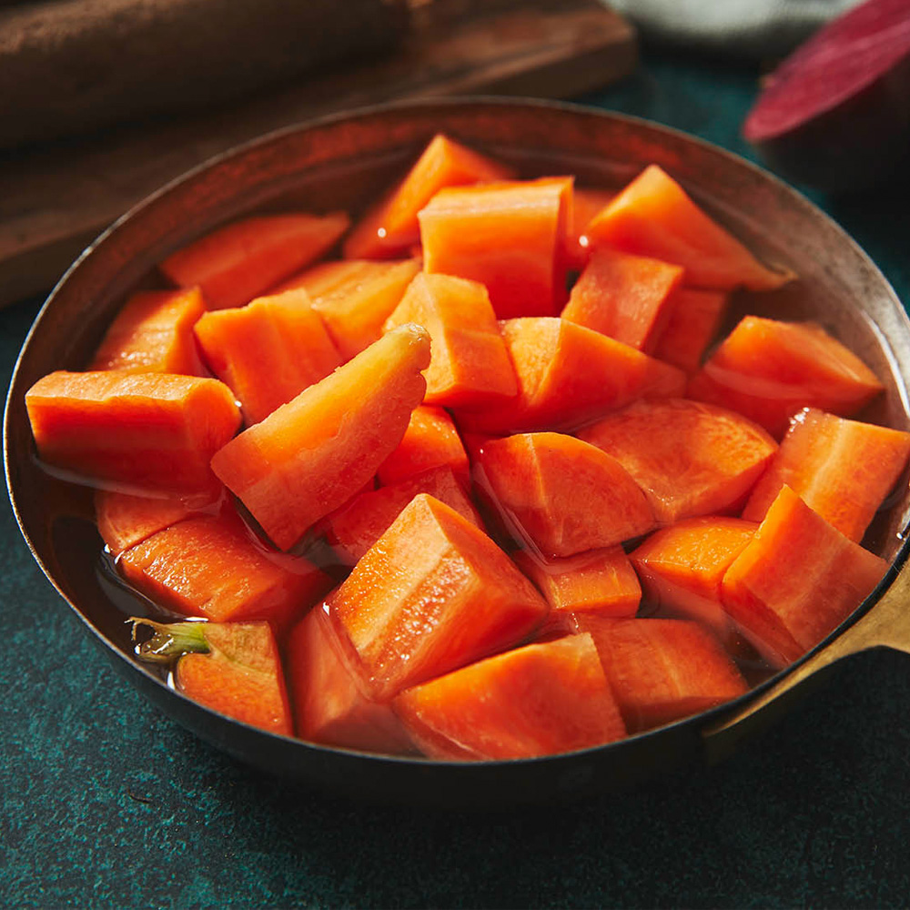 Close up image of a pan of chopped up carrots