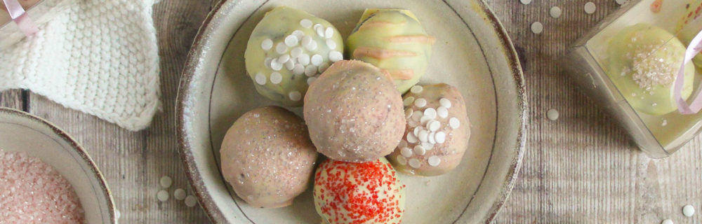 Cookie Cheesecake Truffles piled on top of each other on a rustic plate