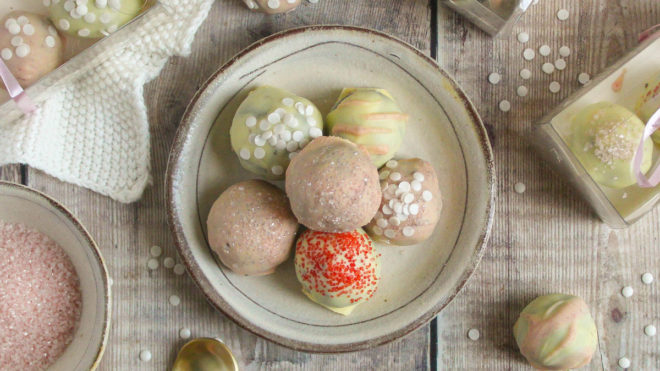 Cookie Cheesecake Truffles piled on top of each other on a rustic plate
