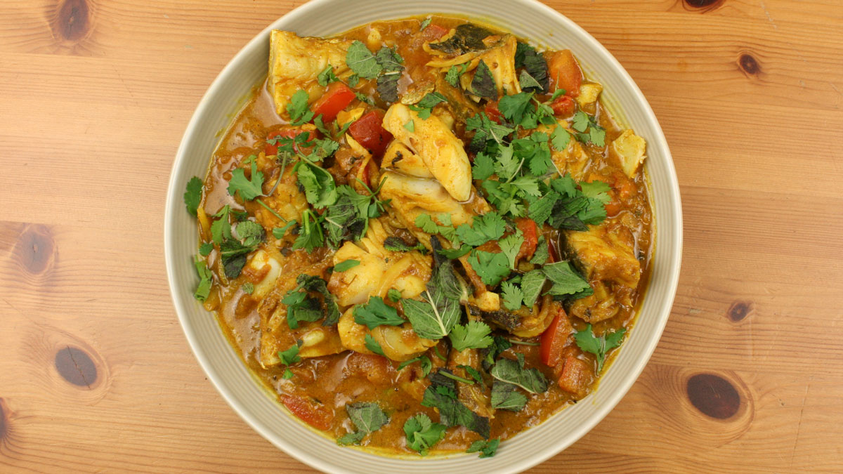 Rafi's Spicebox Do Piyaza Curry Pack with Coley served in a white bowl topped with coriander