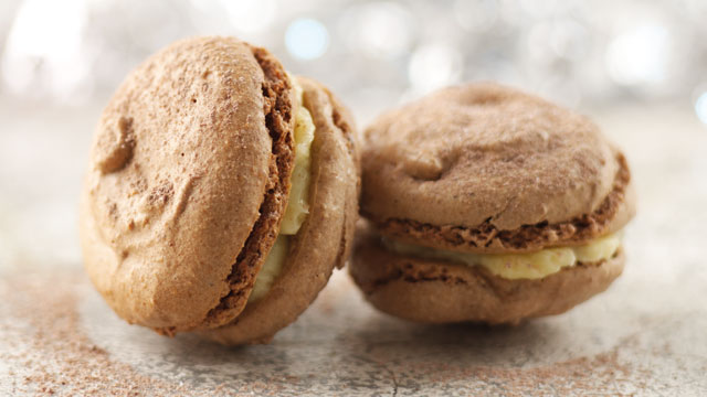 Two Chocolate Macarons with Hazelnuts and Grand Marnier, served on a plate