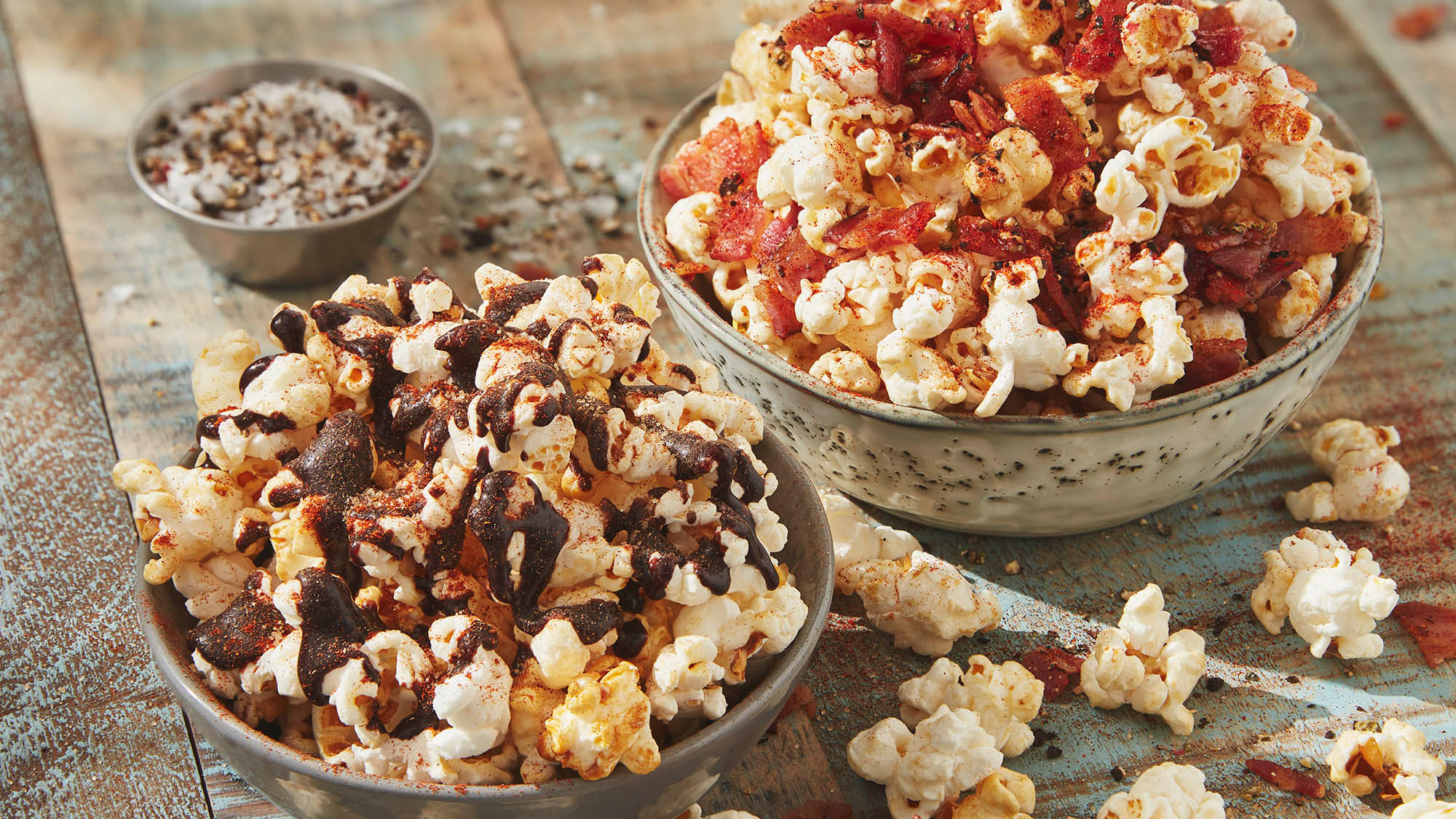 2 bowls of popcorn with different toppings