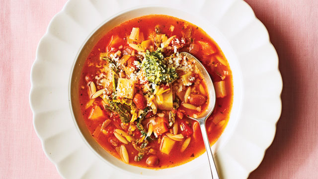 Winter Vegetable Minestrone Soup served in a white bowl with a spoon sitting in the soup