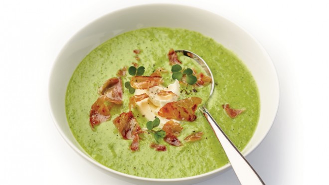 Chilled Yorkshire Pea, Watercress and Cumbrian Ham soup served in a white bowl and topped with a swirl of creme fraiche