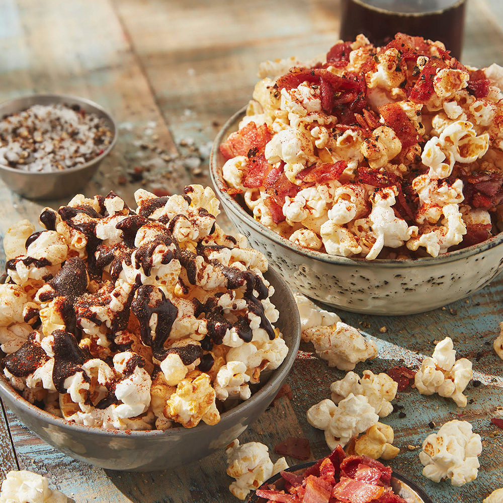S'mores and bacon and maple syrup topped popcorn in bowls