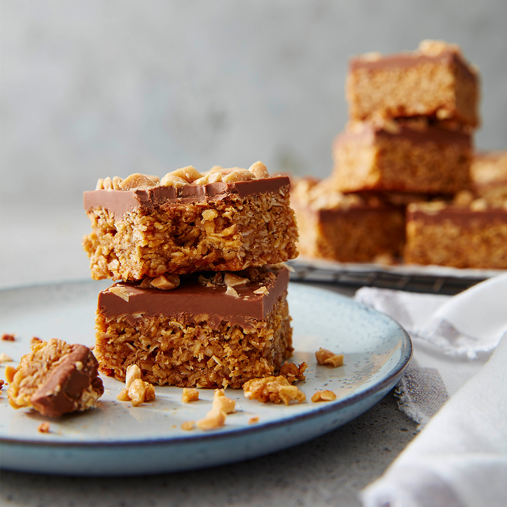 Image of some peanut butter and chocolate flapjacks stacked on top of eachother