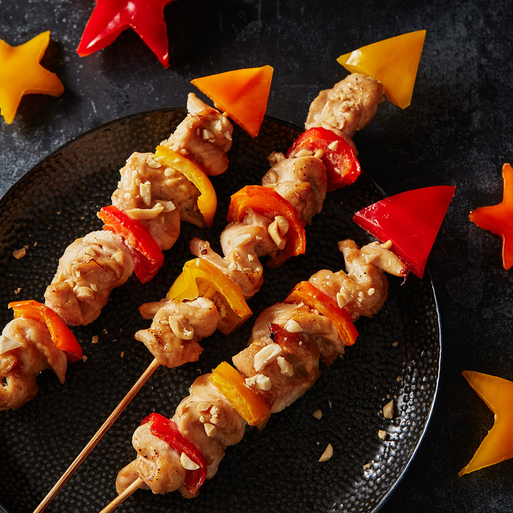 An image of 3 peanut chicken and pepper skewers