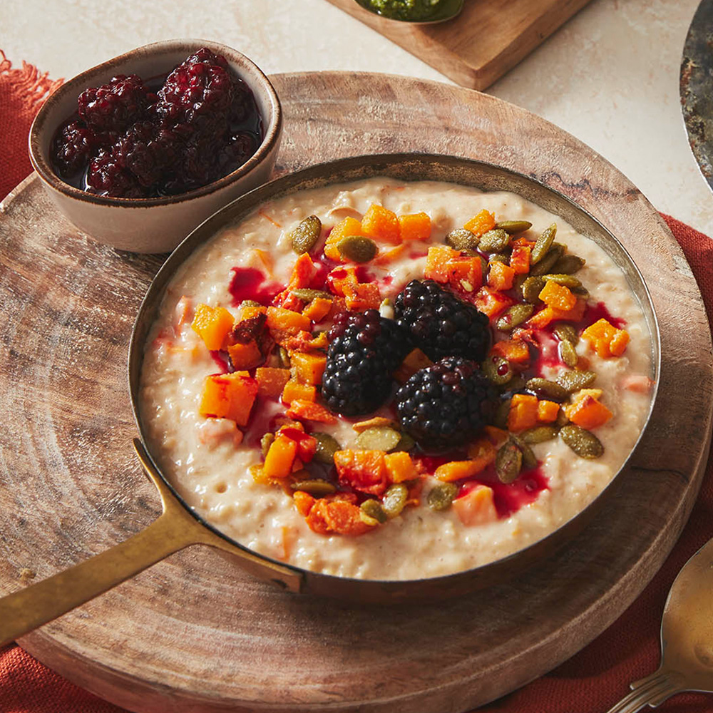 Image of a bowl of porridge with pumpkin, blackberries and autumnal fruit on top