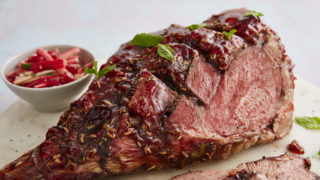 Lamb with Redcurrant and Mint Glaze with a portion sliced off to show the inside of the meat