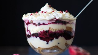 Over The Top Sherry Berry Christmas Trifle topped with flaked almonds and pomegranate seeds