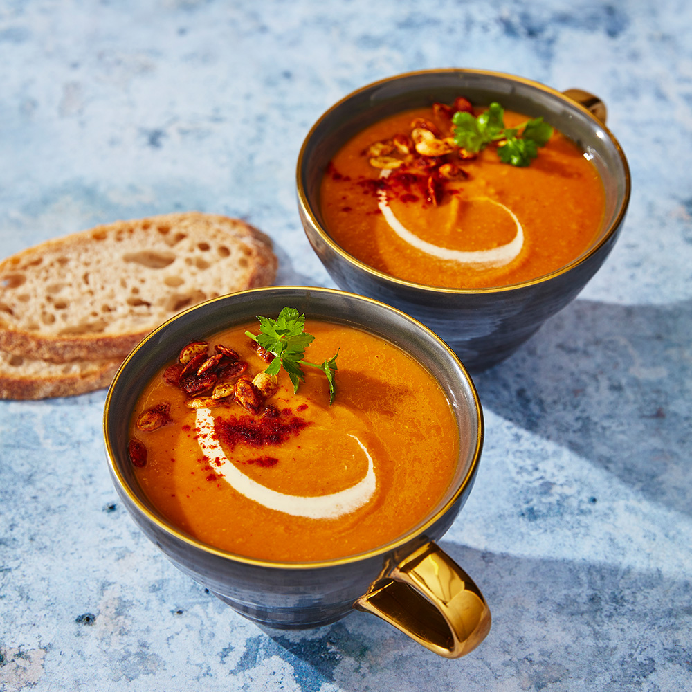 Image of two bowls of spiced red lentil and butternut squash soup
