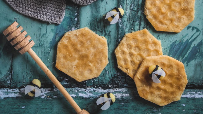 Honey Shortbread served on a blue background with decorative bees