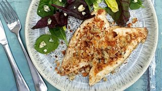 Fish Fillets with blue cheese crumb served with a side salad on a blue plate