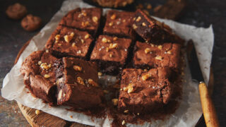 Walnut and mushroom brownies cut into squares in a baking tray