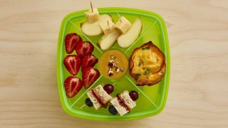 Crustless Quiche Lunchbox with various fruit snacks