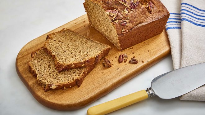 Healthier Banana Bread served on a wooden board and sliced