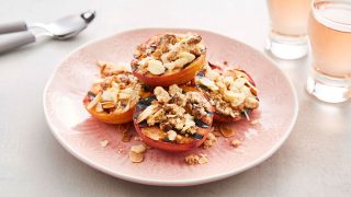 BBQ Grilled Peaches with Amaretti Crumble served on a pink plate