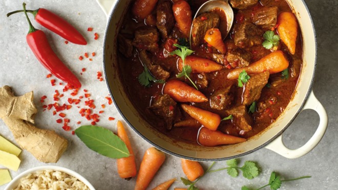 Spiced Beef and Coconut Curry served in a casserole dish topped with parsley