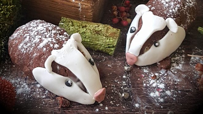 Buttercream Sponge Cake Bertie Badgers served on a wooden board and sprinkled with icing sugar