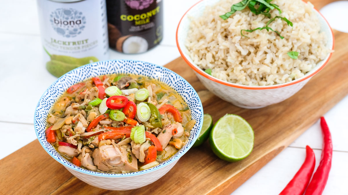 Biona's Organic Vegan Thai Jackfruit Curry served in a blue bowl with a bowl of rice
