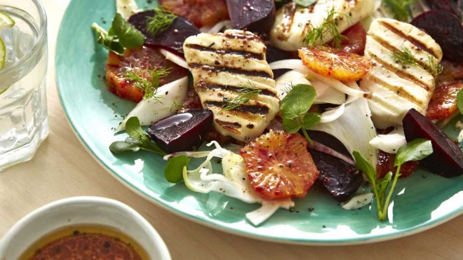 Blood Orange, Beetroot and Griddled Halloumi Salad served on a blue plate and sprinkled with parsley and dill