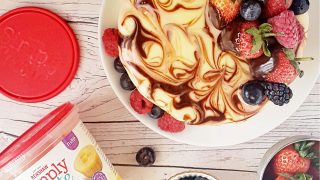 Marble Mirror Cake served on a white plate and topped with fresh berries