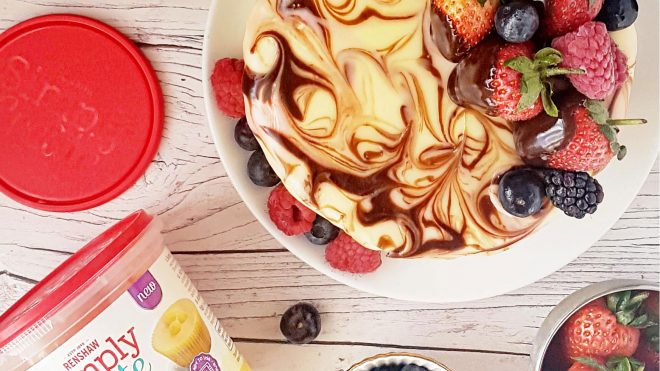 Marble Mirror Cake served on a white plate and topped with fresh berries