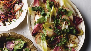 Chicory, Apple and Walnut Salad served on a white dish topped with walnuts