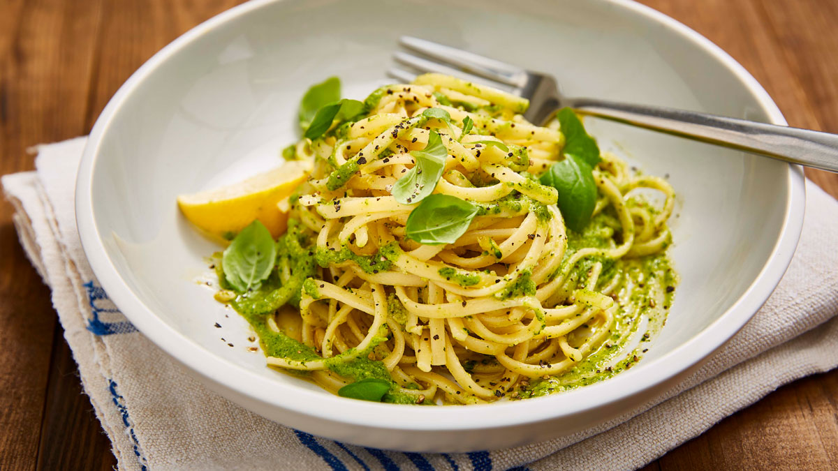 Vegan Lemon and Broccoli Pesto served over pasta in a white bowl