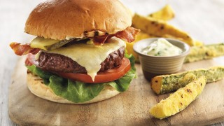 Gourmet Beef Burger served on a bun, with Courgette Chips on a board