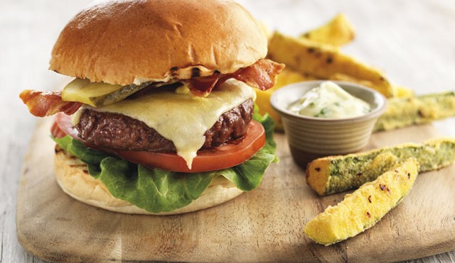 Gourmet Beef Burger served on a bun, with Courgette Chips on a board