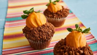 Carrot Patch Cupcakes served on a striped tablecloth