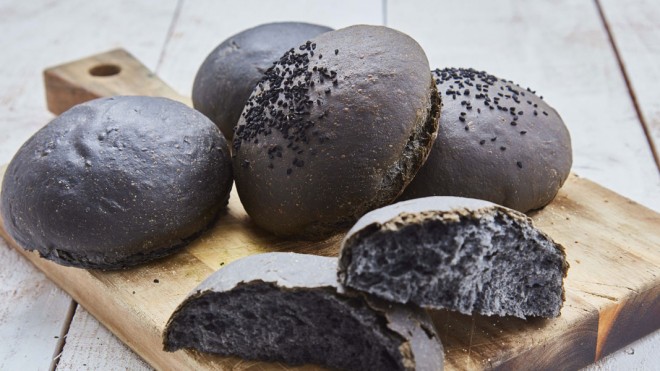 Charcoal Brioche Buns served on a wooden board